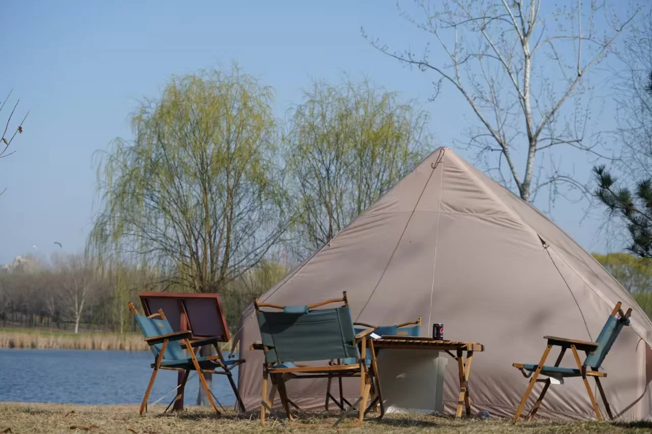 Compact inflatable cabin tent set up with a small outdoor seating area