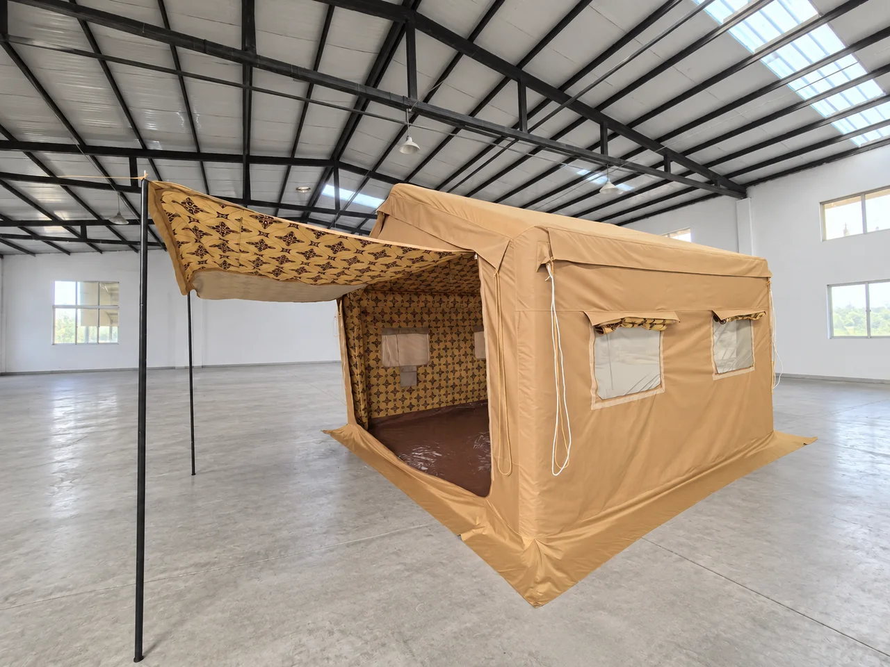 Tan 16 square metre inflatable Majlis tent set up inside a workshop