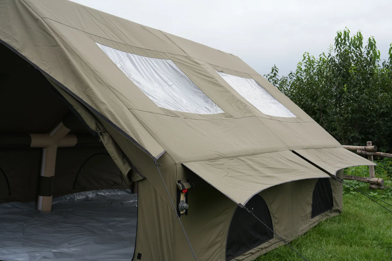 Olive 12 square metre inflatable lodge with the front open and roof-light panels visible