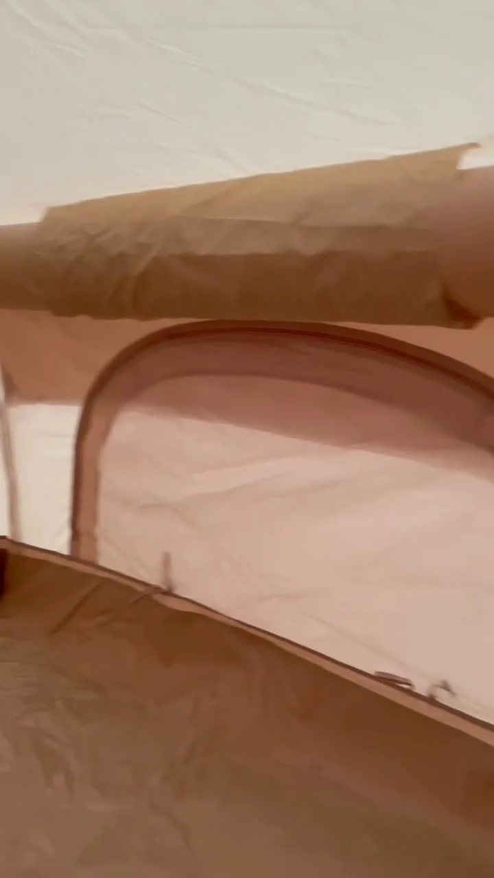 Interior of a compact inflatable tent showing the low wall, floor edge and side opening