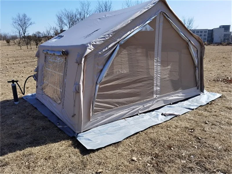 Nine square metre inflatable camping tent with front canopy on grass