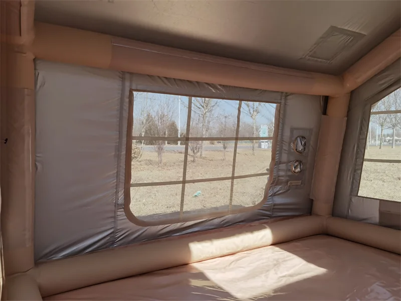 Empty interior of a nine square metre inflatable tent showing window and roof opening