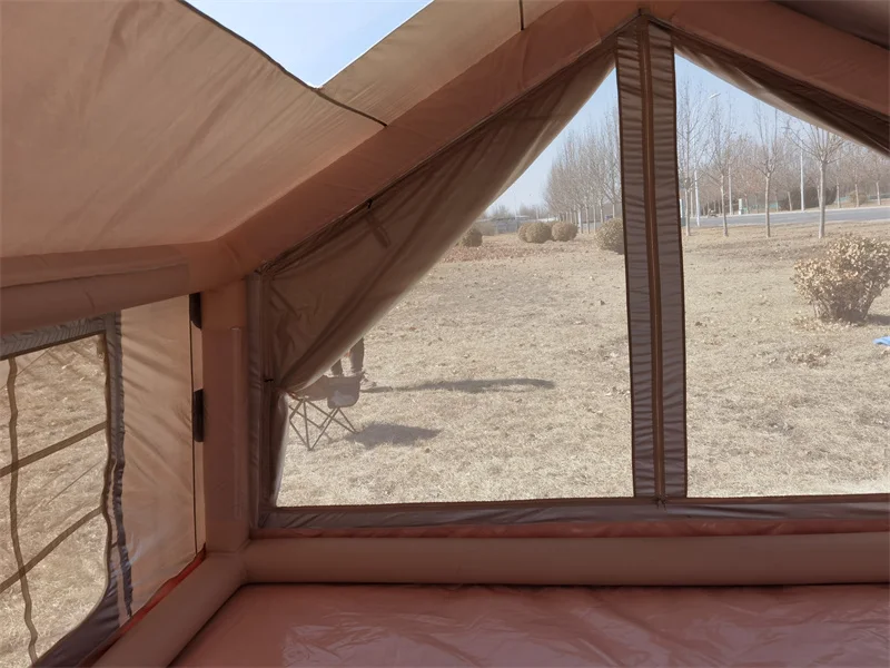 Interior front view of a nine square metre inflatable tent showing the entrance and air frame