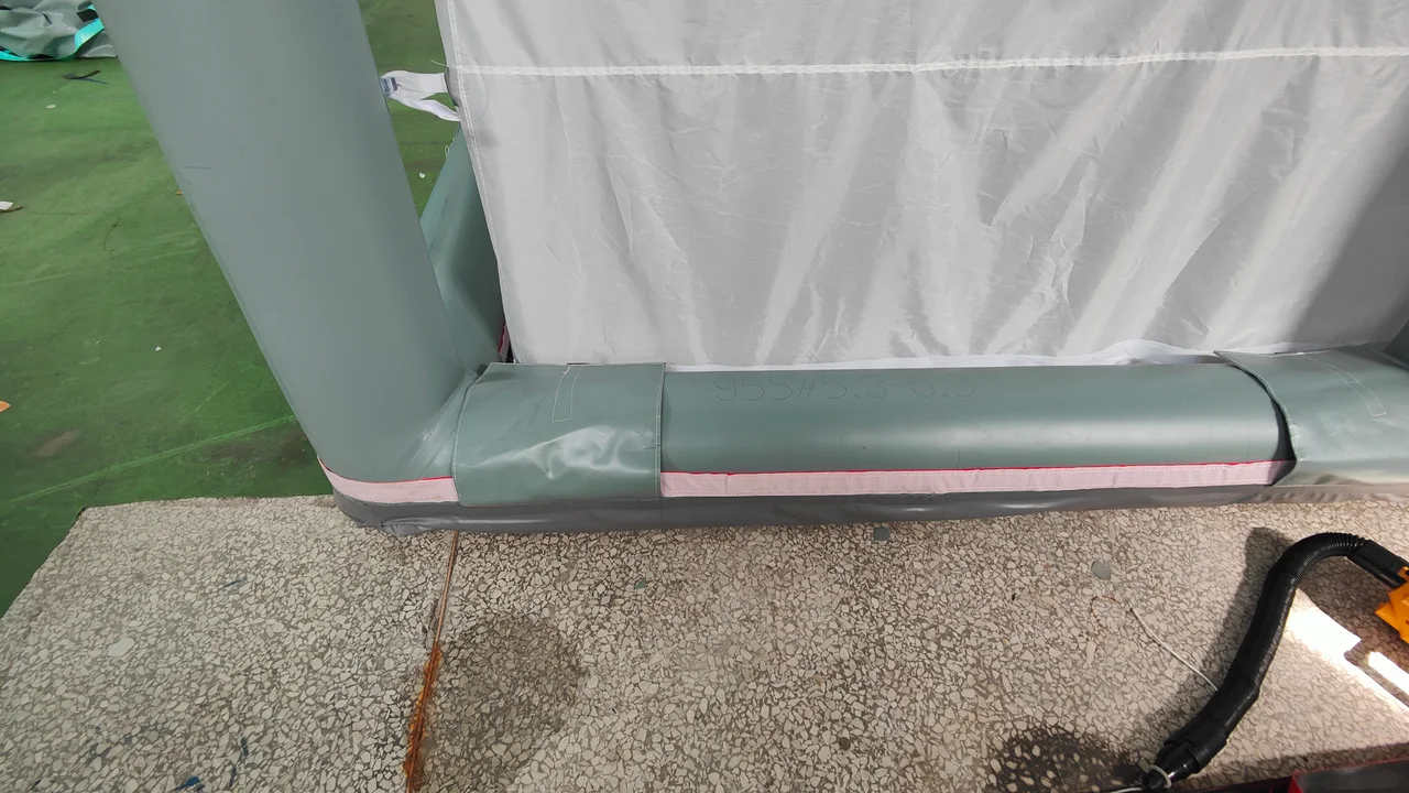 Close view of an inflatable tent air-beam junction and sleeve connection
