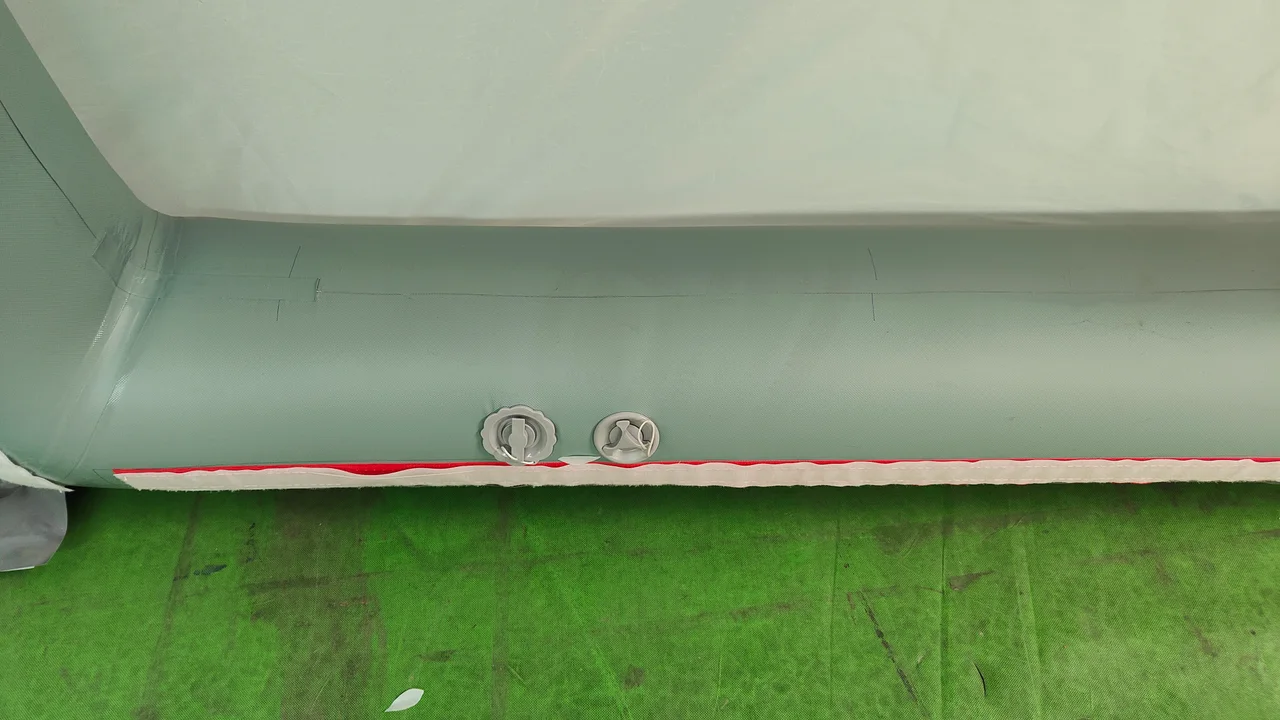 Two valves beside the attachment edge of an inflatable tent air beam