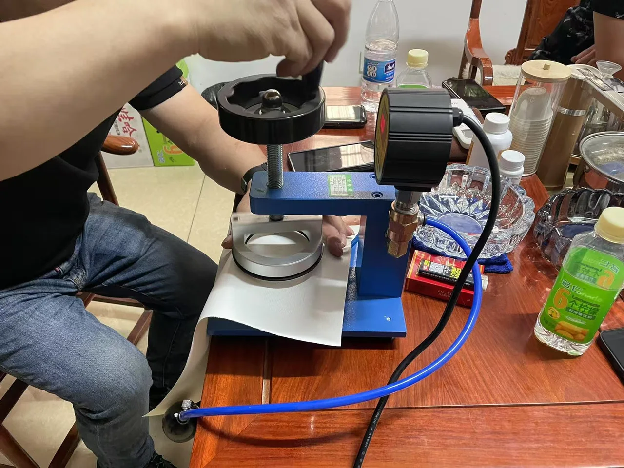 Operator placing a material sample in factory inspection equipment