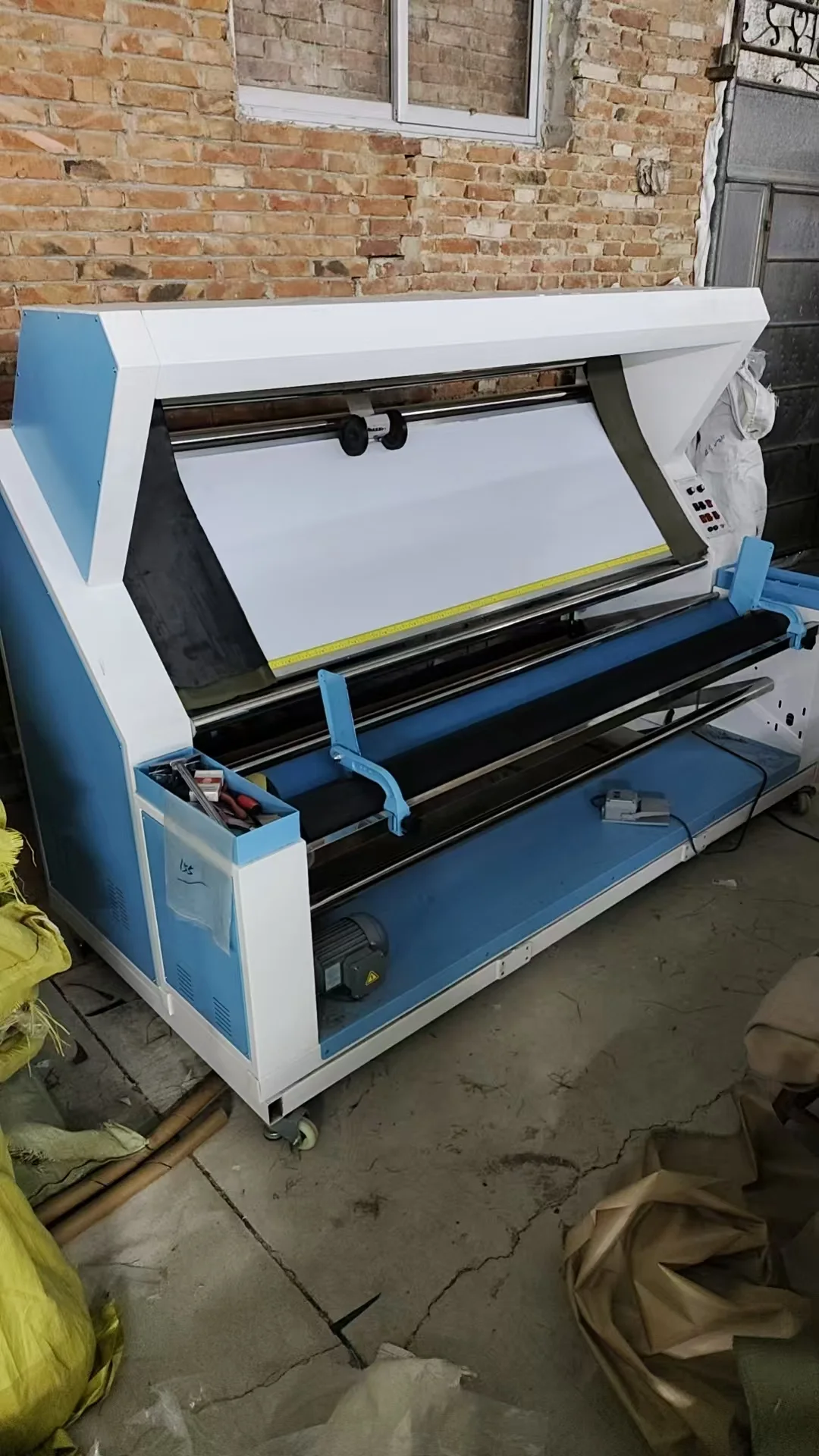 Operator working with digital fabric cutting equipment in the tent factory