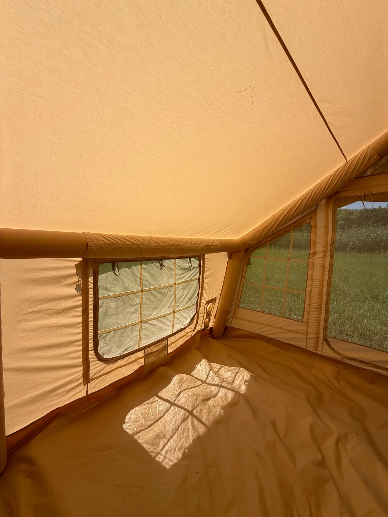 Interior view of an LT-18.16 inflatable tent showing side windows and air-beam geometry