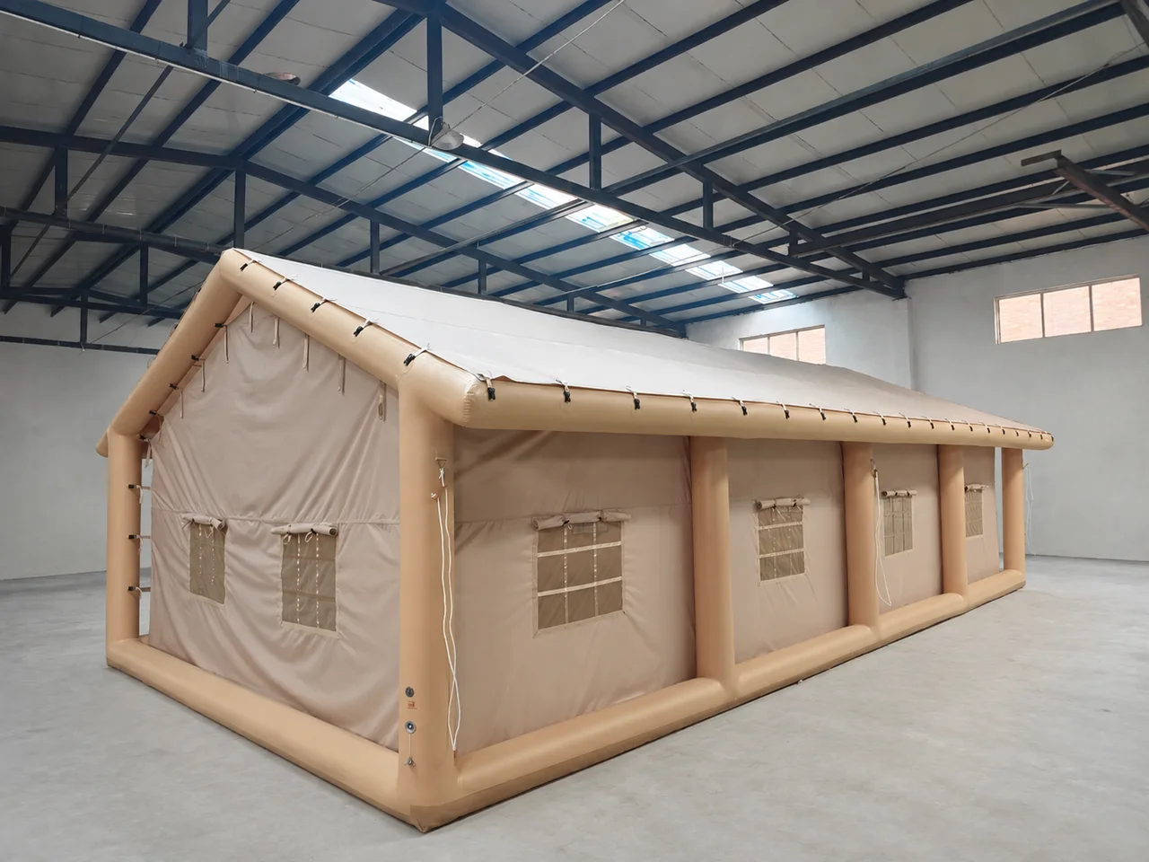 Long inflatable Majlis-style camping tent viewed from the front corner in a workshop