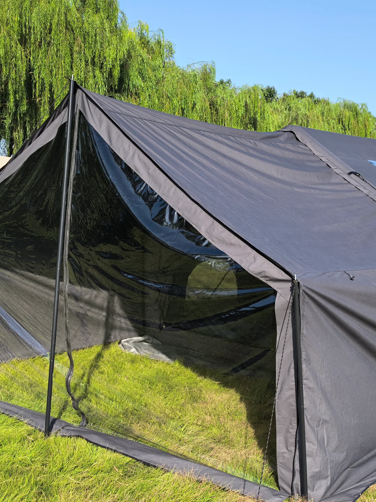 Front enclosure and side profile of a grey LT-07 inflatable camping tent on grass