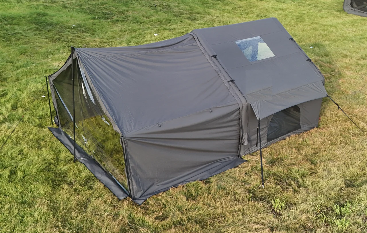 Grey LT-07 inflatable camping tent with an extended front enclosure set up on grass