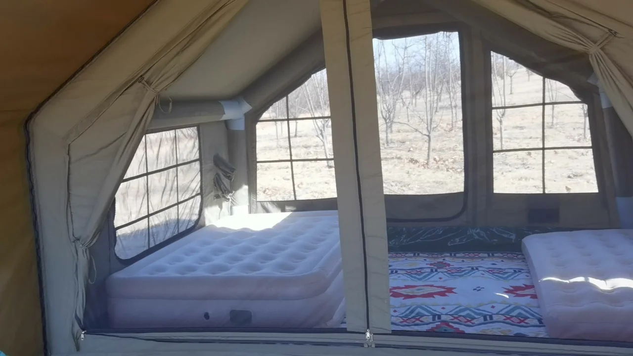 Interior of an LT-09 inflatable camping tent with two temporary air beds and visible air beams