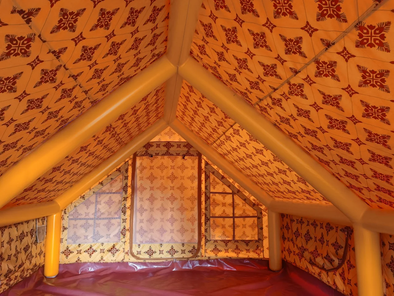 Interior of a Majlis-style inflatable tent showing the primary air-beam frame and junctions
