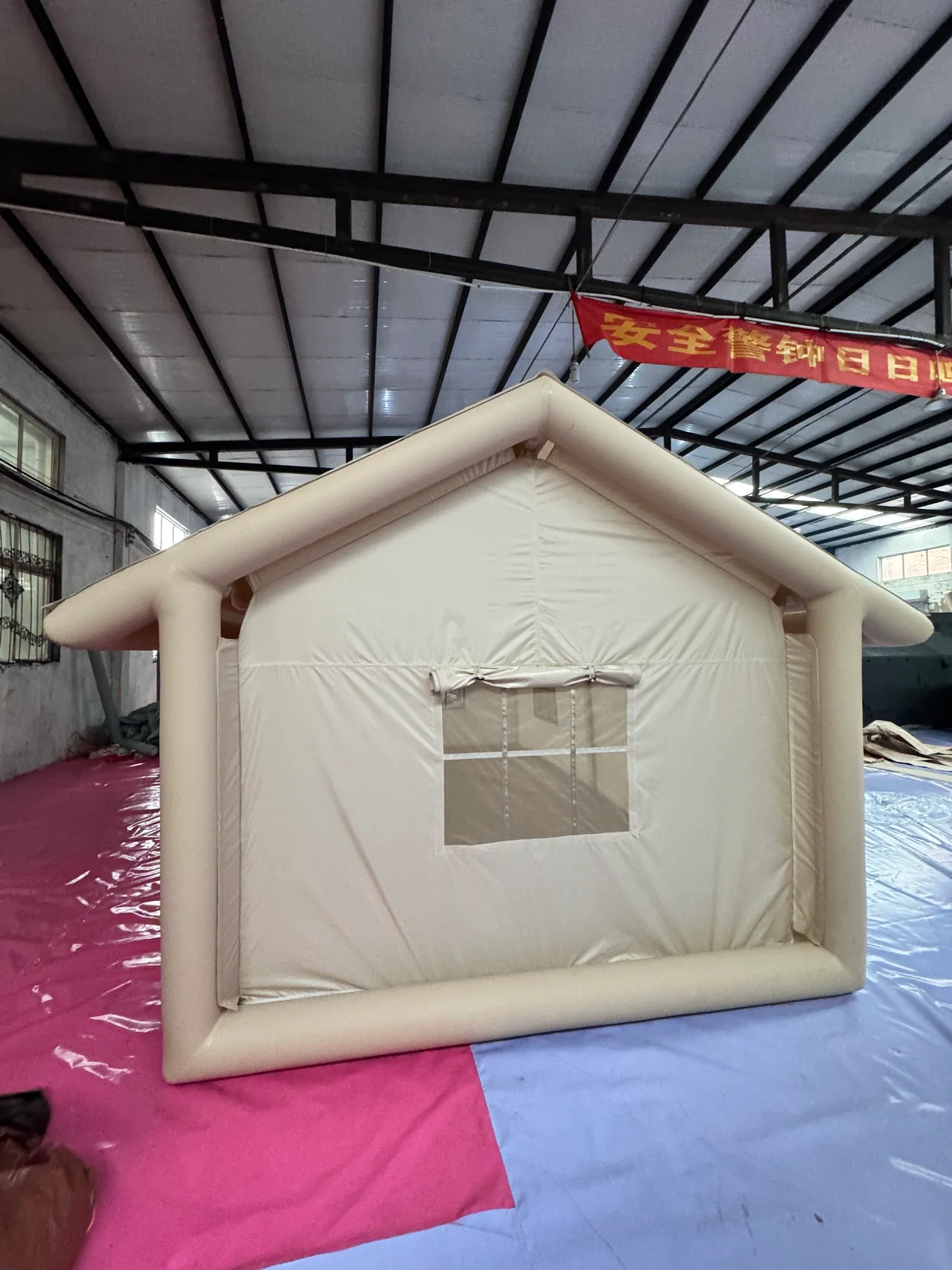 Inflatable camping tent set up for review inside the workshop