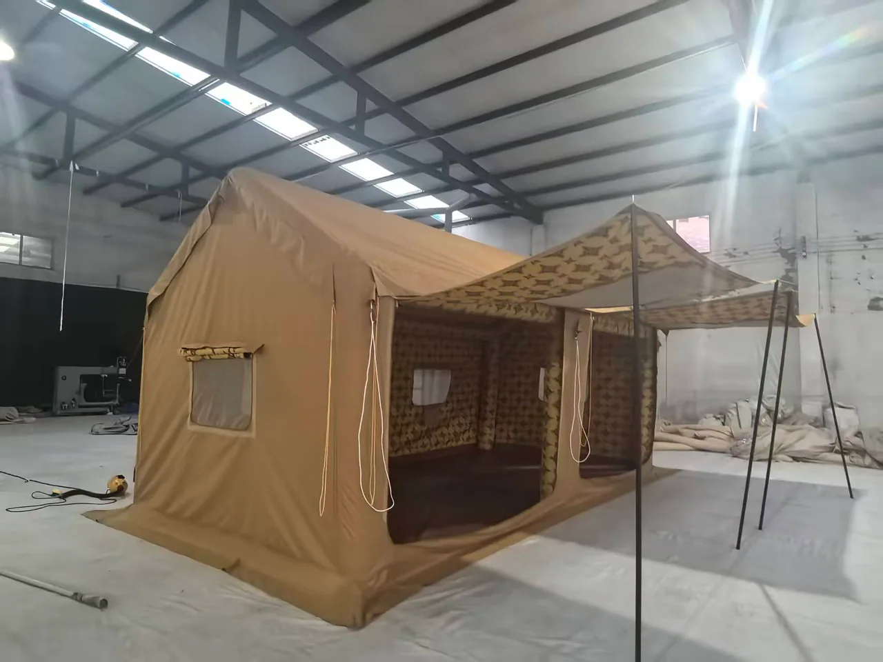 Majlis-style camping tent with the front canopy raised inside the workshop