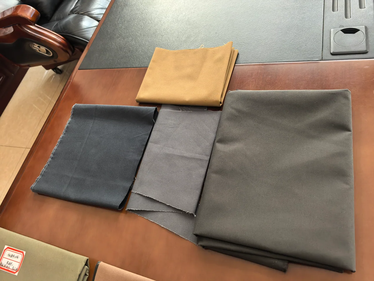 Physical tent fabric samples arranged for colour and material review